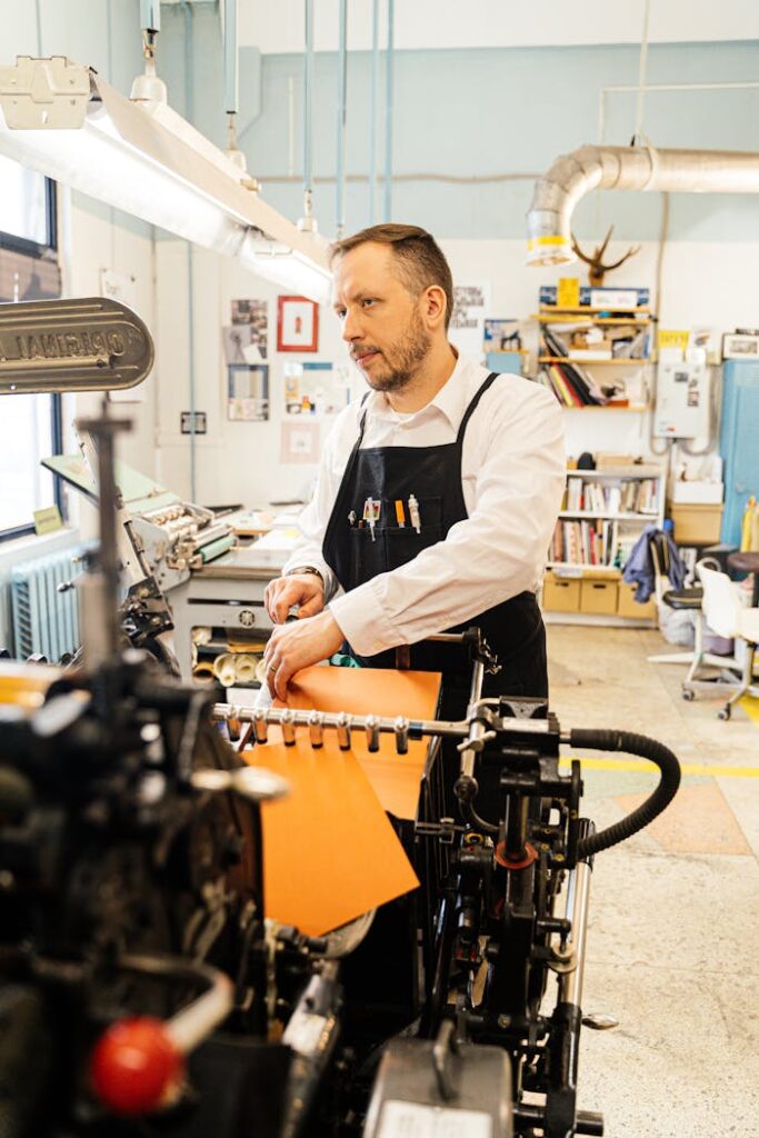 man-using-a-traditional-printing-and-binding-machine-in-a-studio-6620988 Man Using a Traditional Printing and Binding Machine in a Studio